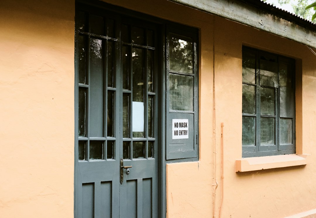 A building facade with a glazed door and window